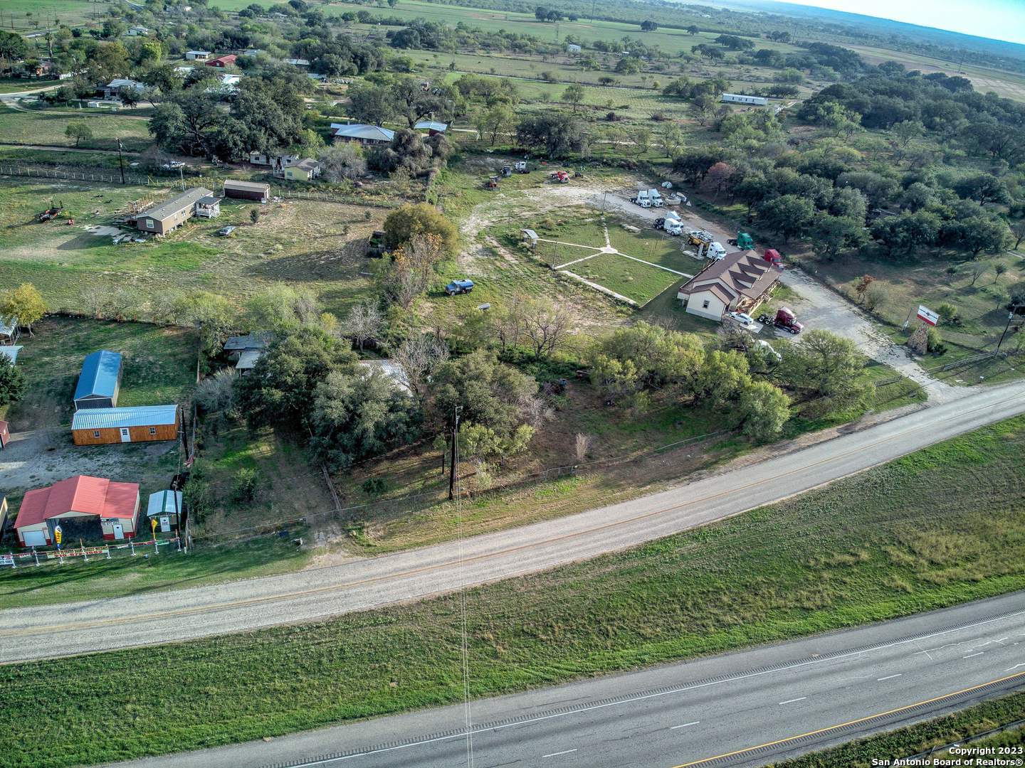 17770 Interstate 35 Lytle, TX 78052 - Photo 30 of 32 an aerial view of residential houses with outdoor space and trees