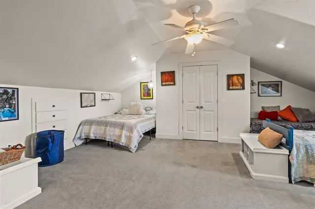 a spacious bedroom with a bed and a chandelier