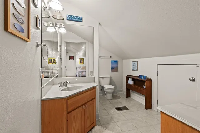 a bathroom with a sink a toilet and a mirror
