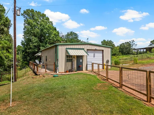 a view of a house with wooden floor and a yard