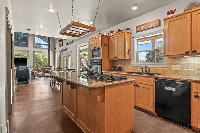 a kitchen with stainless steel appliances granite countertop a stove and a sink