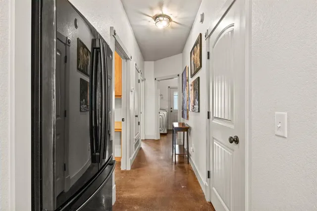 a view of hallway with wooden floor