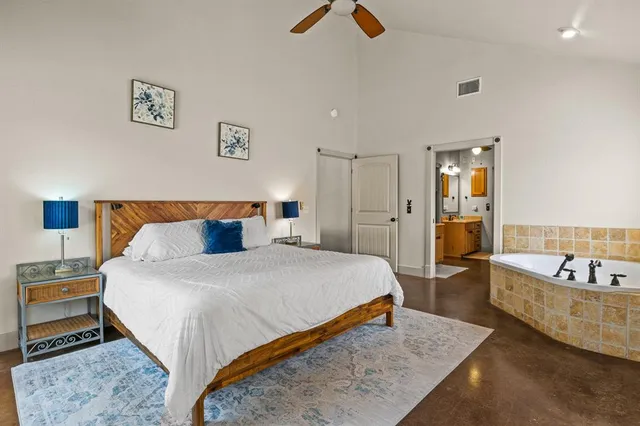 a spacious bedroom with a bed and a couch