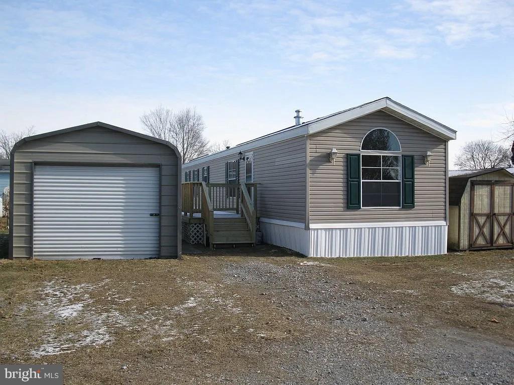 a view of a house with a yard and garage