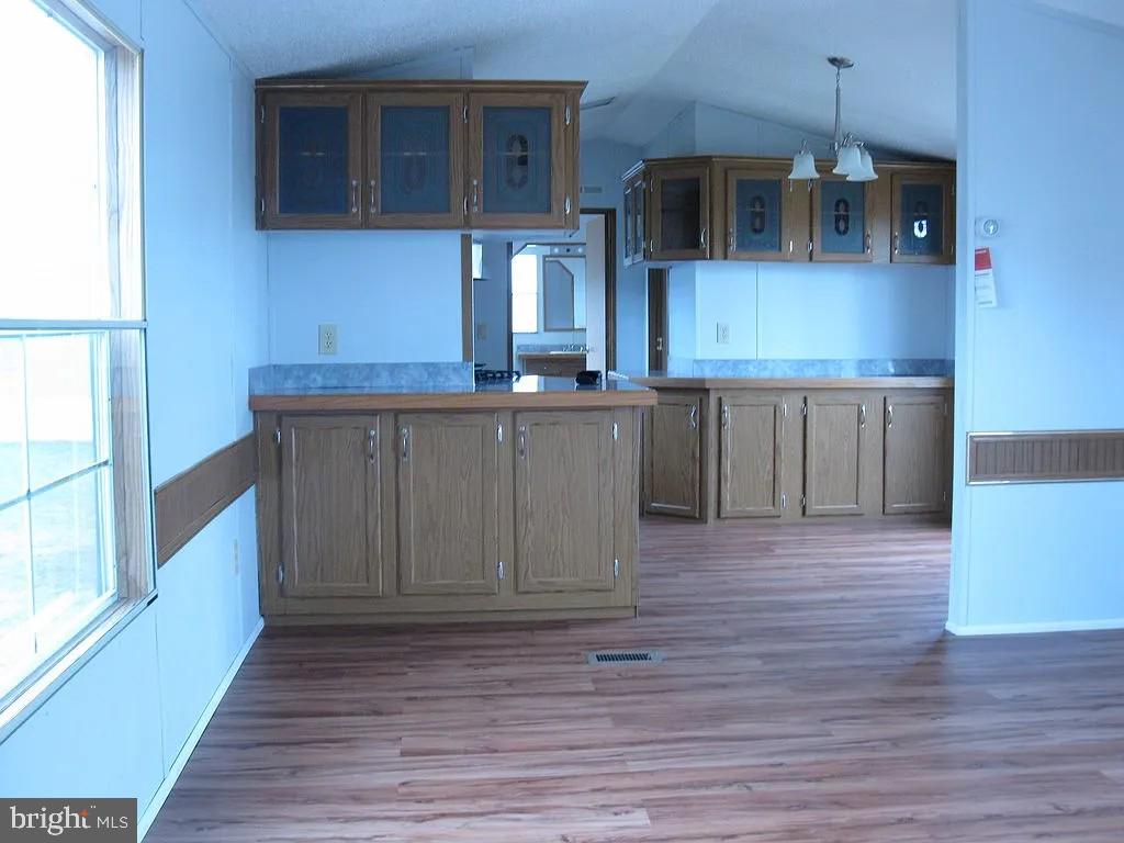 1910 Schubert Road, Unit 19 Bethel, PA 19507 - Photo 2 of 14 a kitchen with stainless steel appliances granite countertop a stove a sink and a microwave