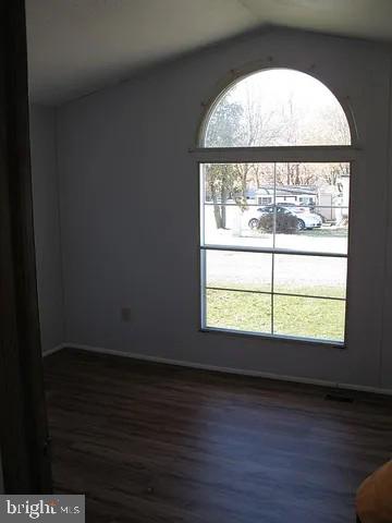 1910 Schubert Road, Unit 19 Bethel, PA 19507 - Photo 8 of 14 a view of an empty room with wooden floor and a window