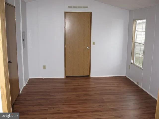 1910 Schubert Road, Unit 19 Bethel, PA 19507 - Photo 10 of 14 a view of an empty room with wooden floor and a window