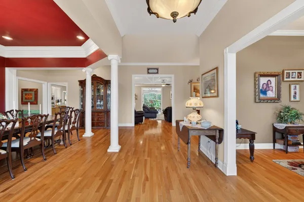 a living room with furniture and a chandelier