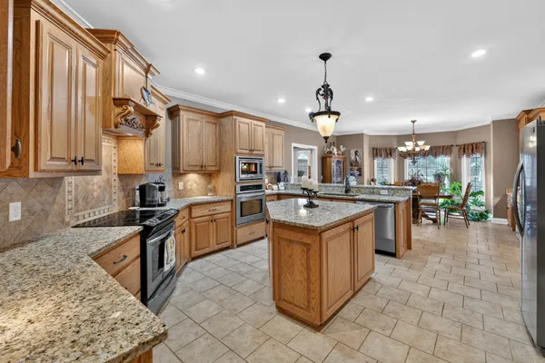 a kitchen with a sink stove and refrigerator