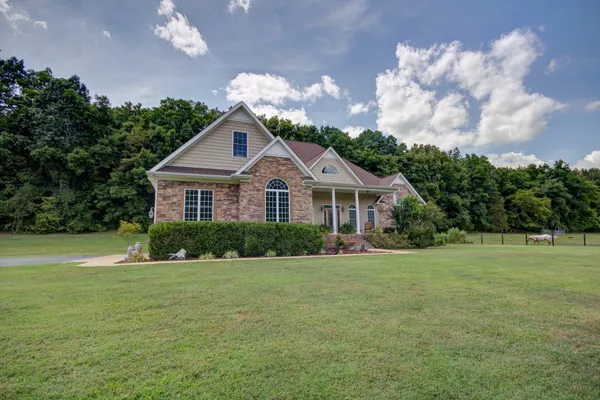 a front view of a house with a yard
