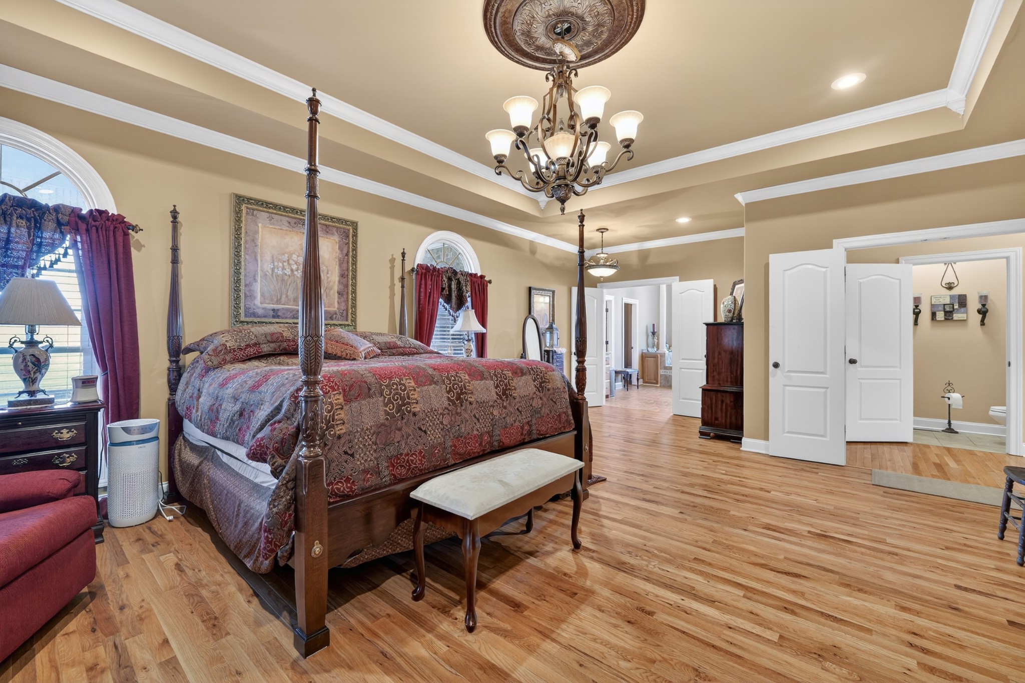 600 Bates Hollow Road Prospect, TN 38477 - Photo 35 of 68 a spacious bedroom that has a bed and a chandelier