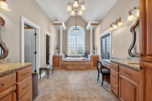 a spacious bedroom with a bed and a walk in closet