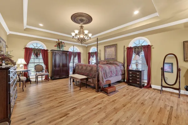 a living room with furniture a ceiling fan and a flat screen tv