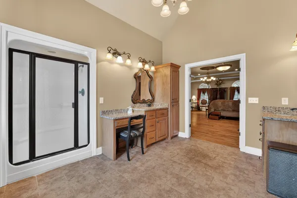 a spacious bedroom with a bed and a walk in closet
