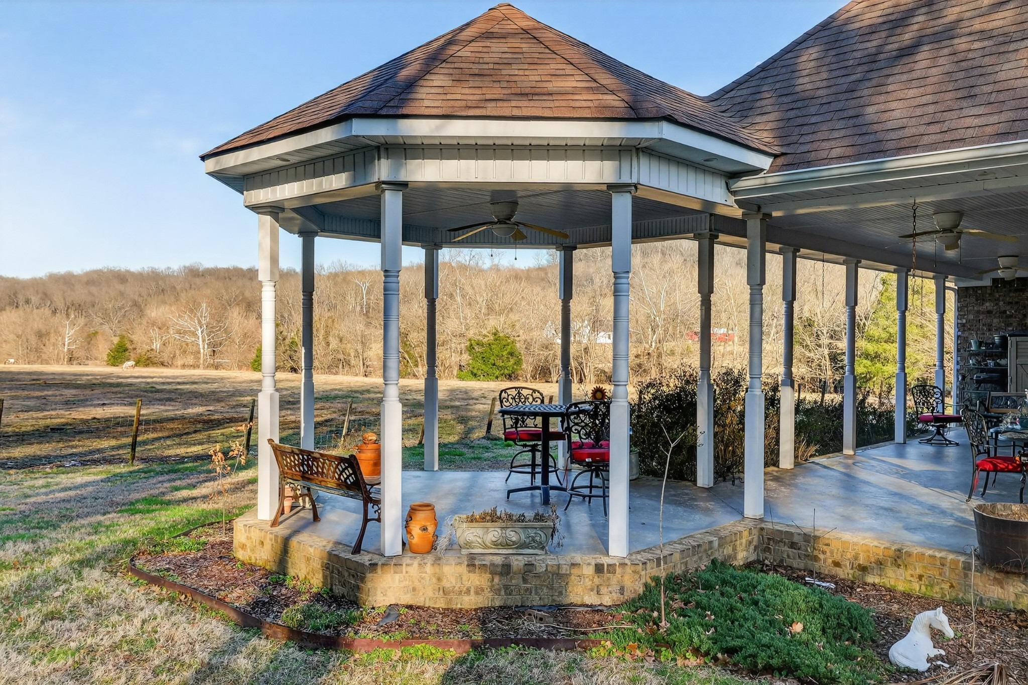 600 Bates Hollow Road Prospect, TN 38477 - Photo 57 of 73 a view of a patio with a dining table and chairs under an umbrella