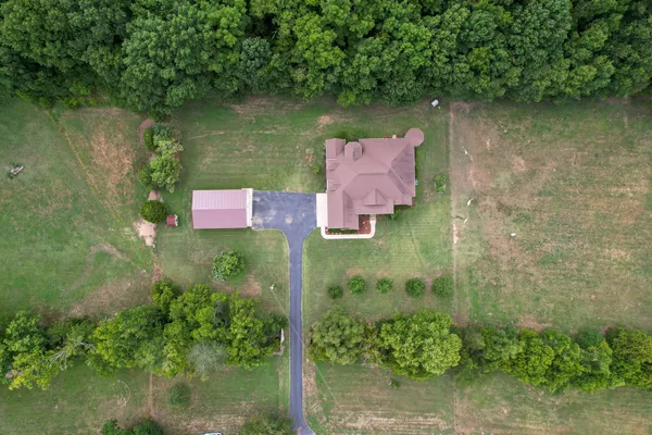 an aerial view of residential house with outdoor space and lake view