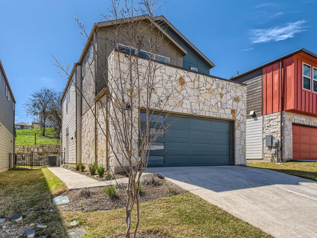 7103 Terrazzo Cottage Lane, Unit 33 Austin, TX 78744 - Photo 1 of 14 a front view of a house with a yard