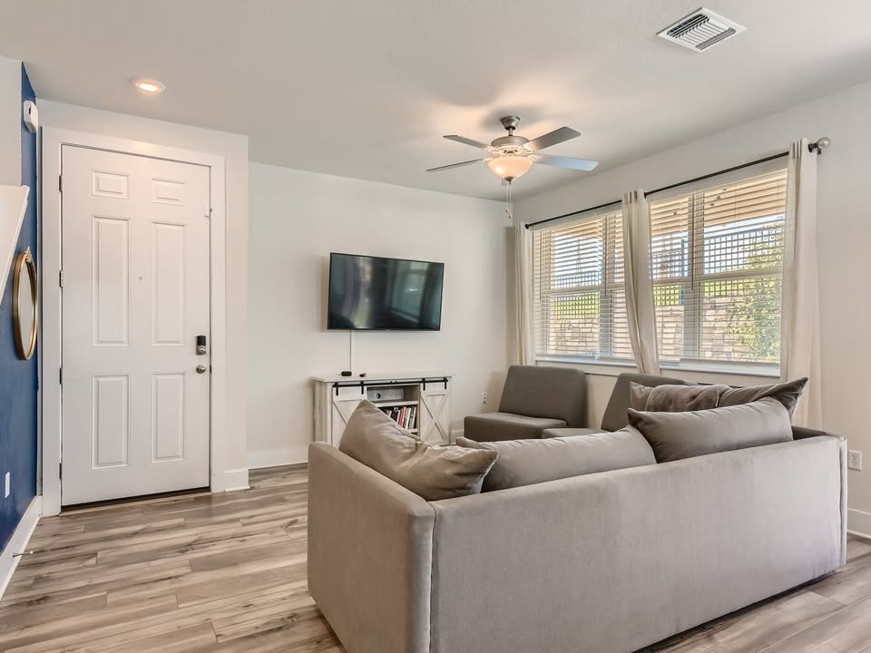 7103 Terrazzo Cottage Lane, Unit 33 Austin, TX 78744 - Photo 3 of 14 a living room with furniture and a flat screen tv