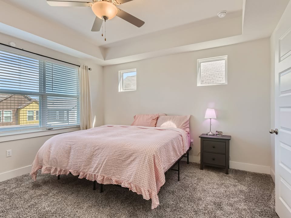 7103 Terrazzo Cottage Lane, Unit 33 Austin, TX 78744 - Photo 7 of 14 a bedroom with a bed and a window