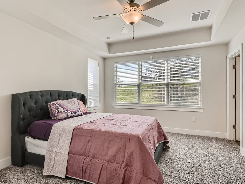 7103 Terrazzo Cottage Lane, Unit 33 Austin, TX 78744 - Photo 8 of 14 a bedroom with a bed and window