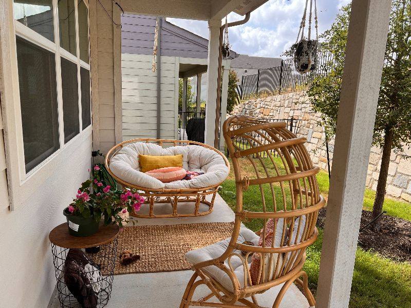 7103 Terrazzo Cottage Lane, Unit 33 Austin, TX 78744 - Photo 10 of 14 a table and chairs in front of a house