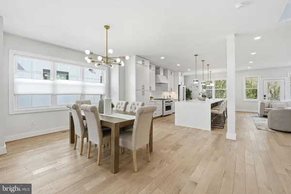 a dining room with furniture and wooden floor