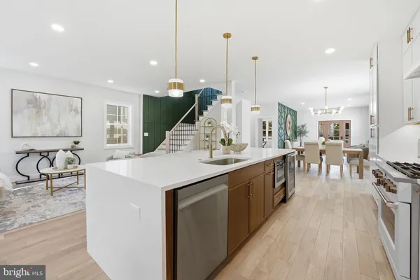 a kitchen with a refrigerator a white table and chairs