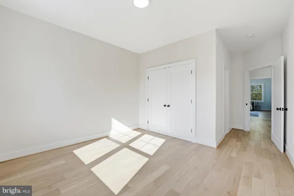 a spacious bedroom with a bed and a couch with window