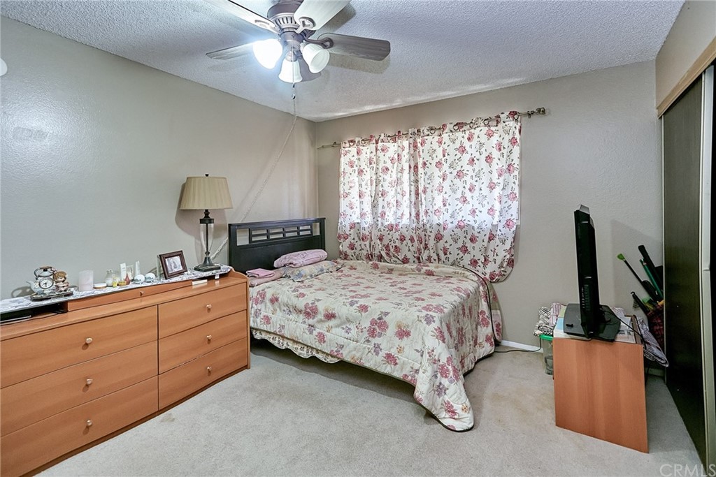 334 Miraleste Drive, Unit 237 San Pedro, CA 90732 - Photo 12 of 20 a bedroom with a bed and a flat tv screen on dresser