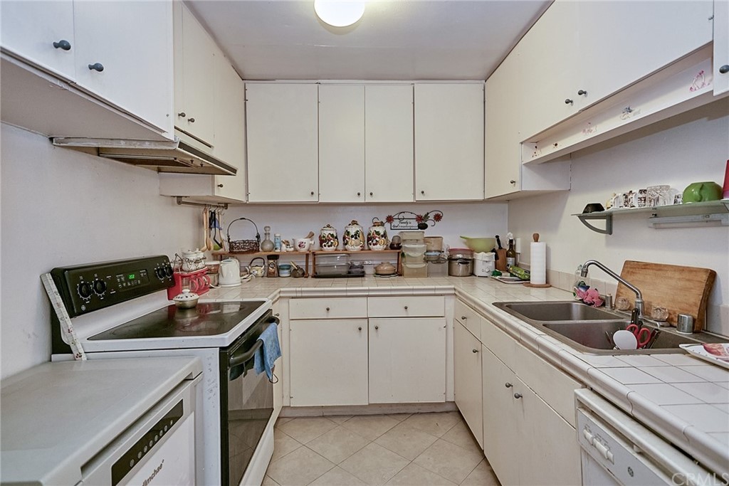 334 Miraleste Drive, Unit 237 San Pedro, CA 90732 - Photo 10 of 20 a kitchen with cabinets appliances a sink and a counter top space