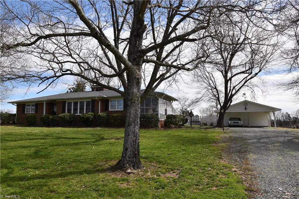 6556 Foster Road Whitsett, NC 27377 - Photo 2 of 27 2 car detached carport with large storage room.