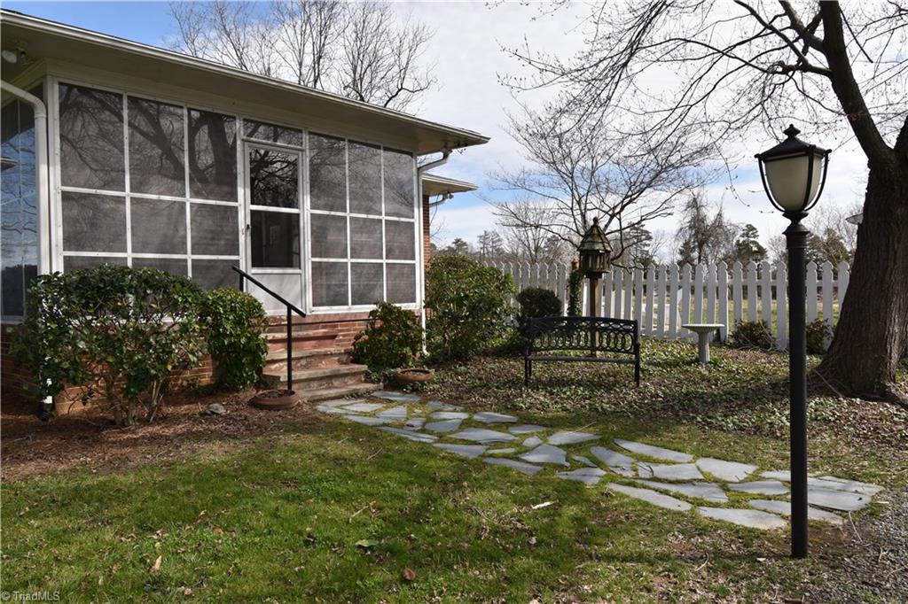 6556 Foster Road Whitsett, NC 27377 - Photo 3 of 27 Large Screened Porch and relaxing park like atmosphere.