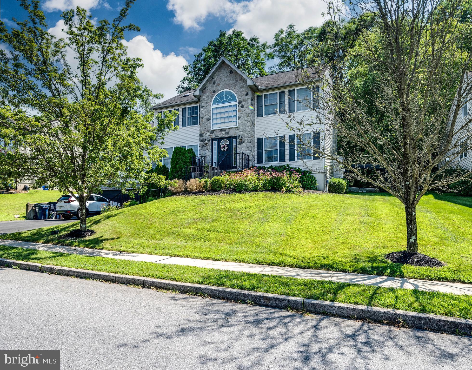 4660 Dunham Drive Reading, PA 19606 - Photo 2 of 48 a view of a big house with a big yard plants and large trees