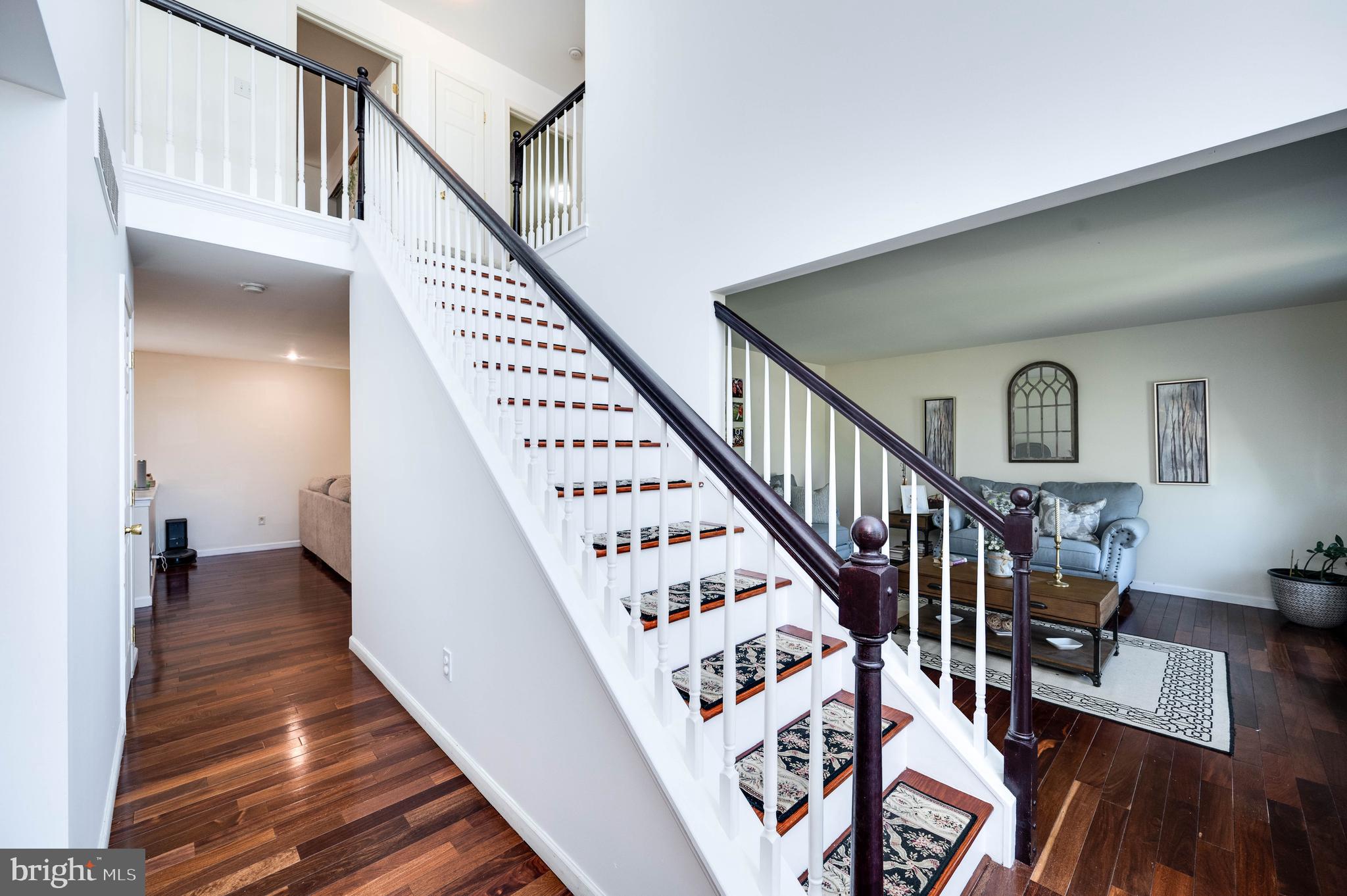 4660 Dunham Drive Reading, PA 19606 - Photo 5 of 48 a view of staircase with lots of frames on wall and wooden floor