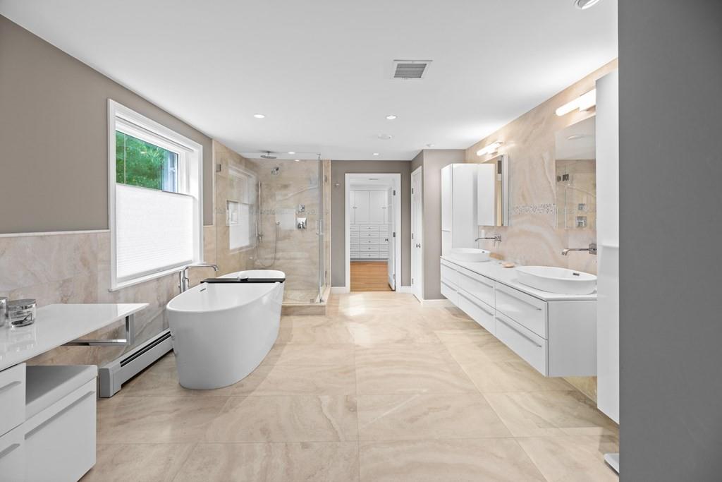 77 Royalston Road Wellesley, MA 02481 - Photo 16 of 30 a bathroom with a tub sink shower and mirror