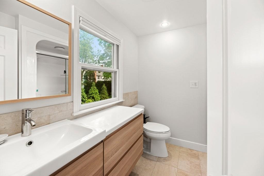 77 Royalston Road Wellesley, MA 02481 - Photo 18 of 30 a bathroom with a sink a toilet and a window