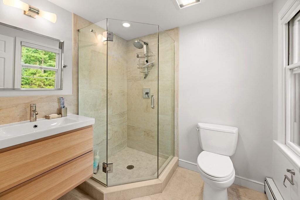 77 Royalston Road Wellesley, MA 02481 - Photo 20 of 30 a bathroom with a shower a sink a toilet and a mirror
