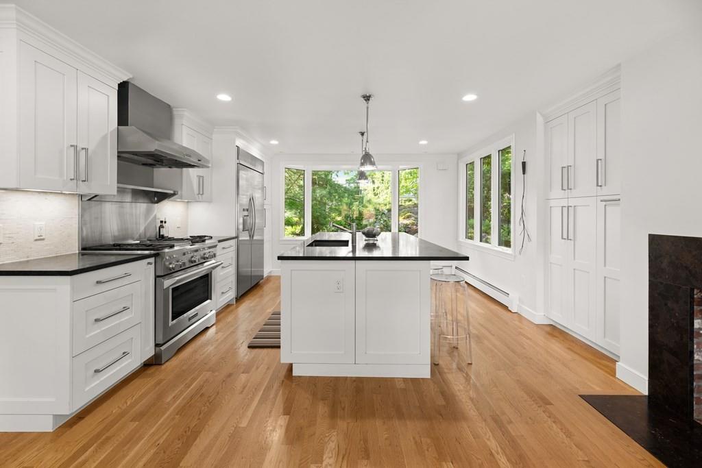 77 Royalston Road Wellesley, MA 02481 - Photo 5 of 30 a large kitchen with stainless steel appliances granite countertop a stove a sink and a refrigerator