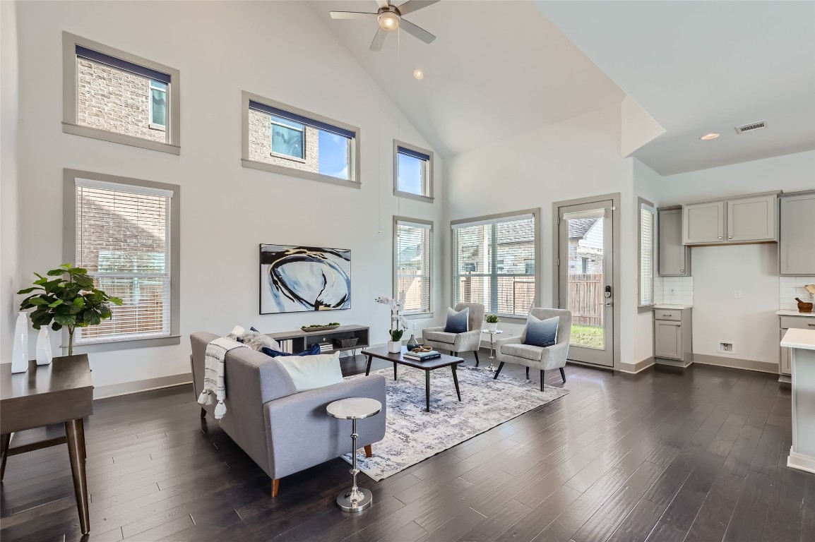a living room with furniture wooden floor and a large window