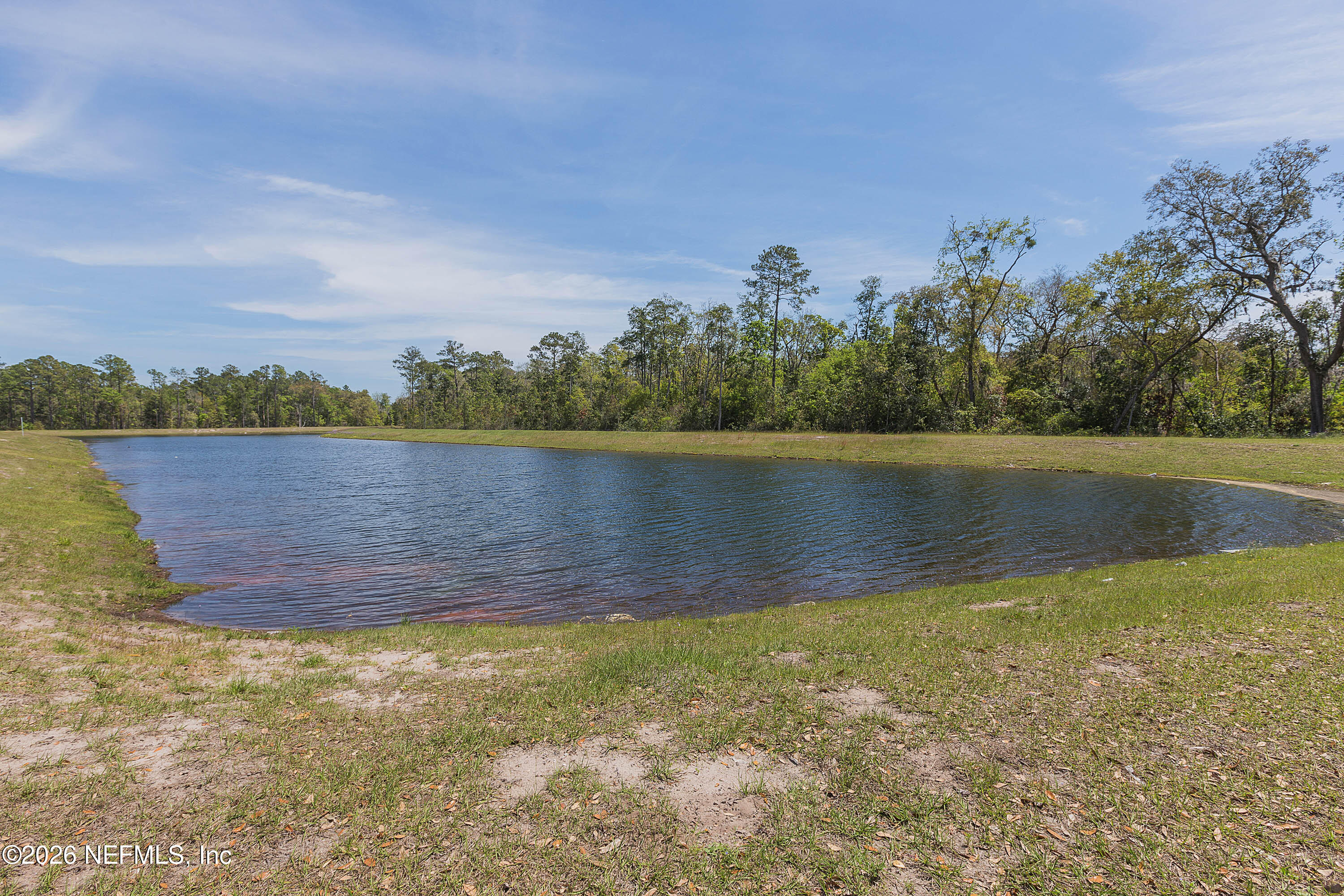4963 Shell Crk Trail Jacksonville, FL 32226 - Photo 26 of 39 a view of a lake with houses in the back