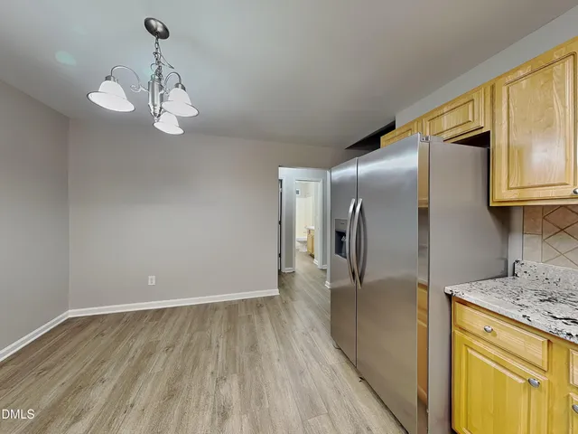 a view of a kitchen with a sink and dishwasher wooden floor