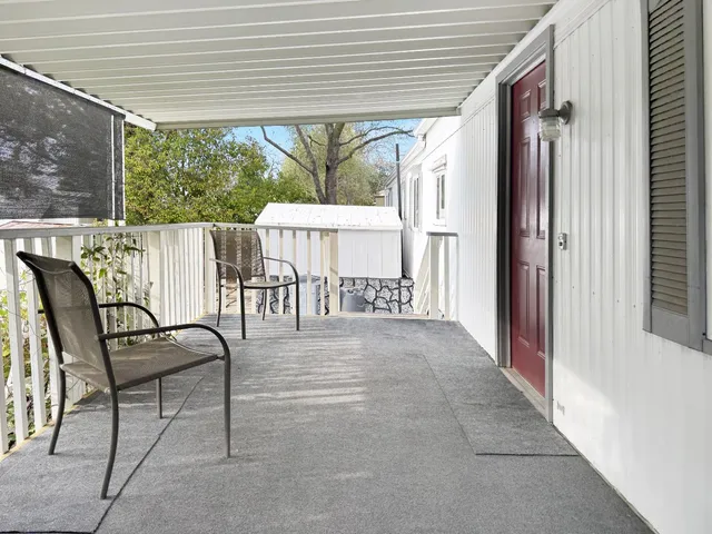a view of a patio with table and chairs and wooden floor