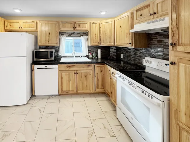 a kitchen with a stove a sink and a refrigerator