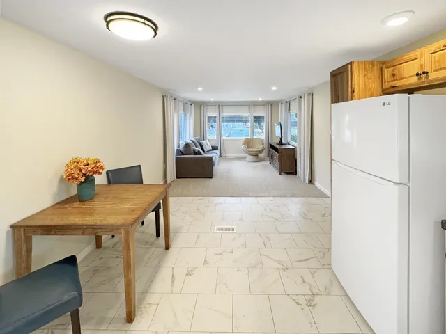a kitchen with refrigerator and cabinets