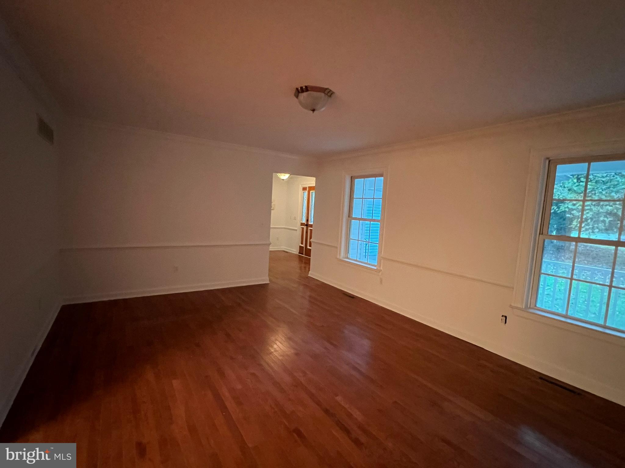 1290 College Road Dover, DE 19904 - Photo 14 of 33 a view of an empty room with wooden floor and a window