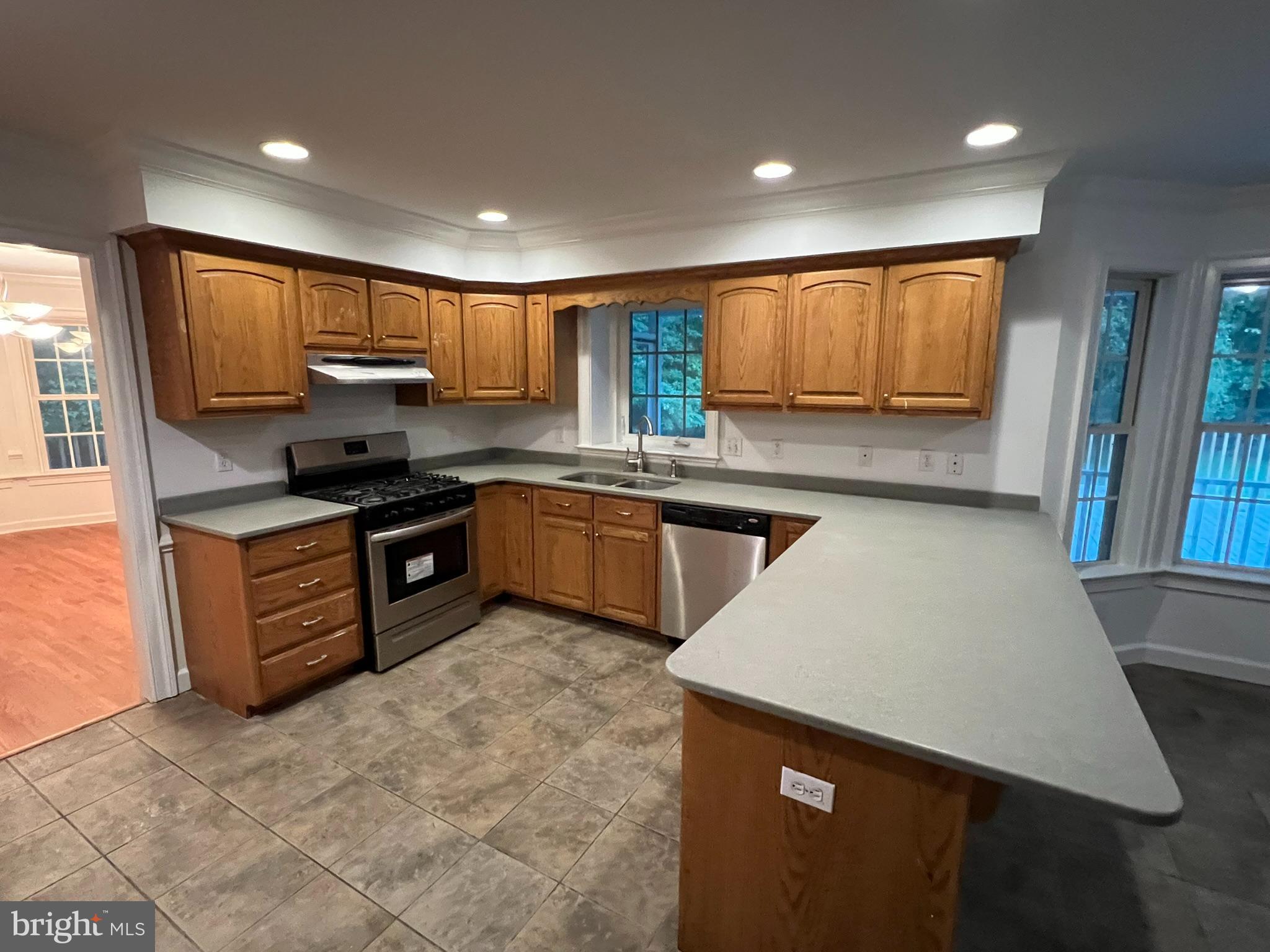 1290 College Road Dover, DE 19904 - Photo 18 of 33 a kitchen with kitchen island granite countertop a sink counter top space appliances and a window