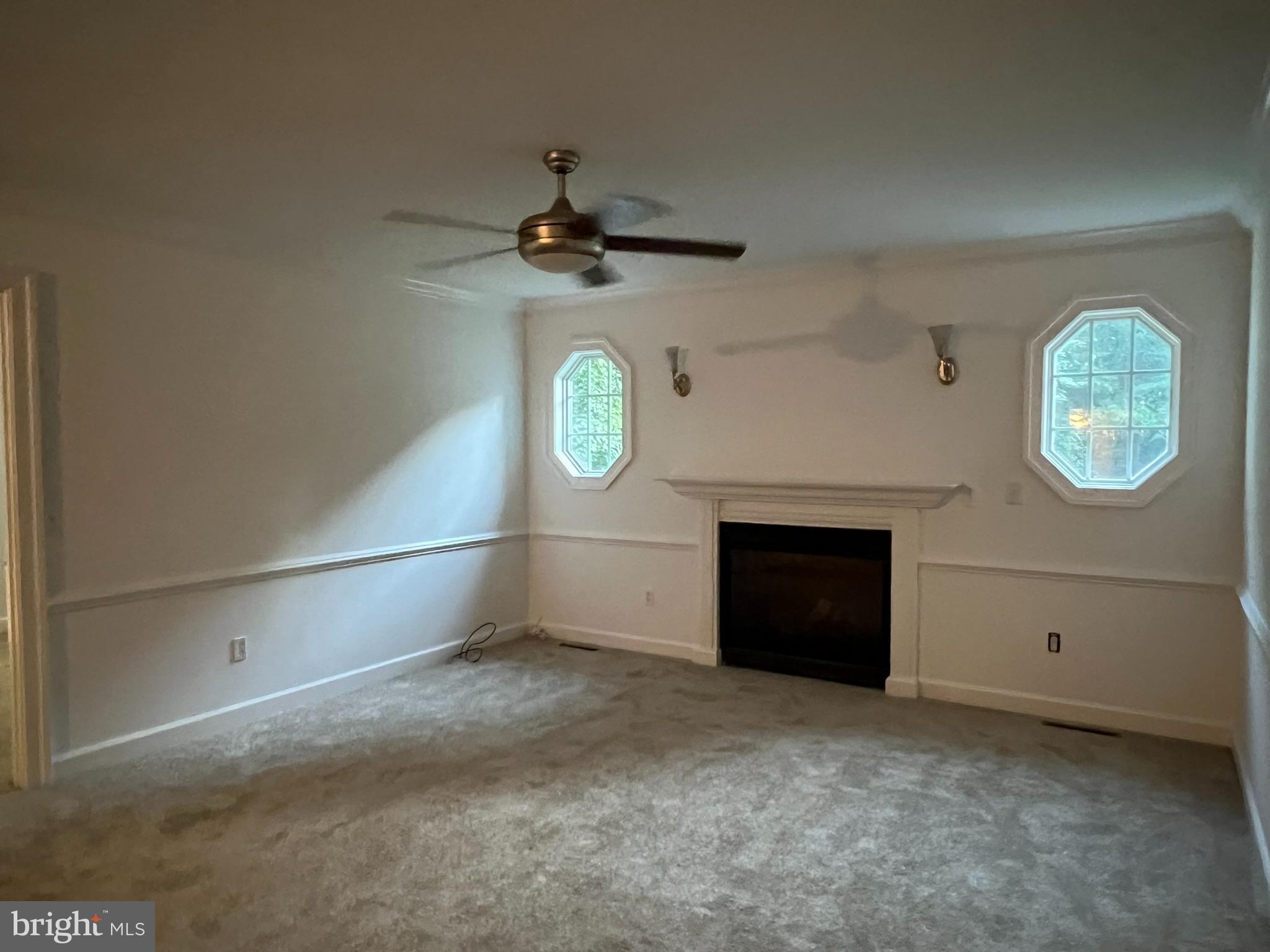 1290 College Road Dover, DE 19904 - Photo 19 of 33 an empty room with windows and fireplace