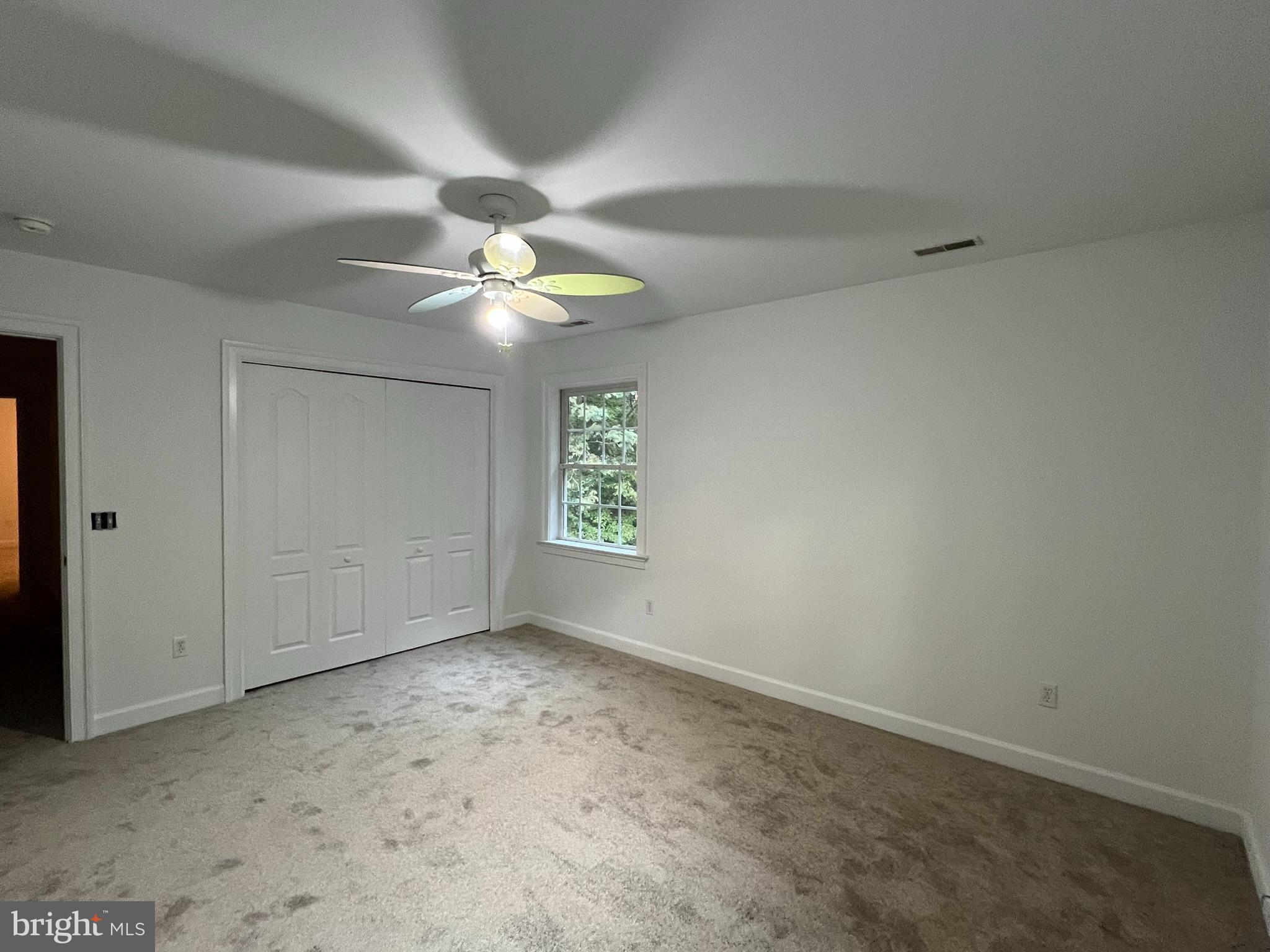 1290 College Road Dover, DE 19904 - Photo 28 of 33 an empty room with a window and a ceiling fan