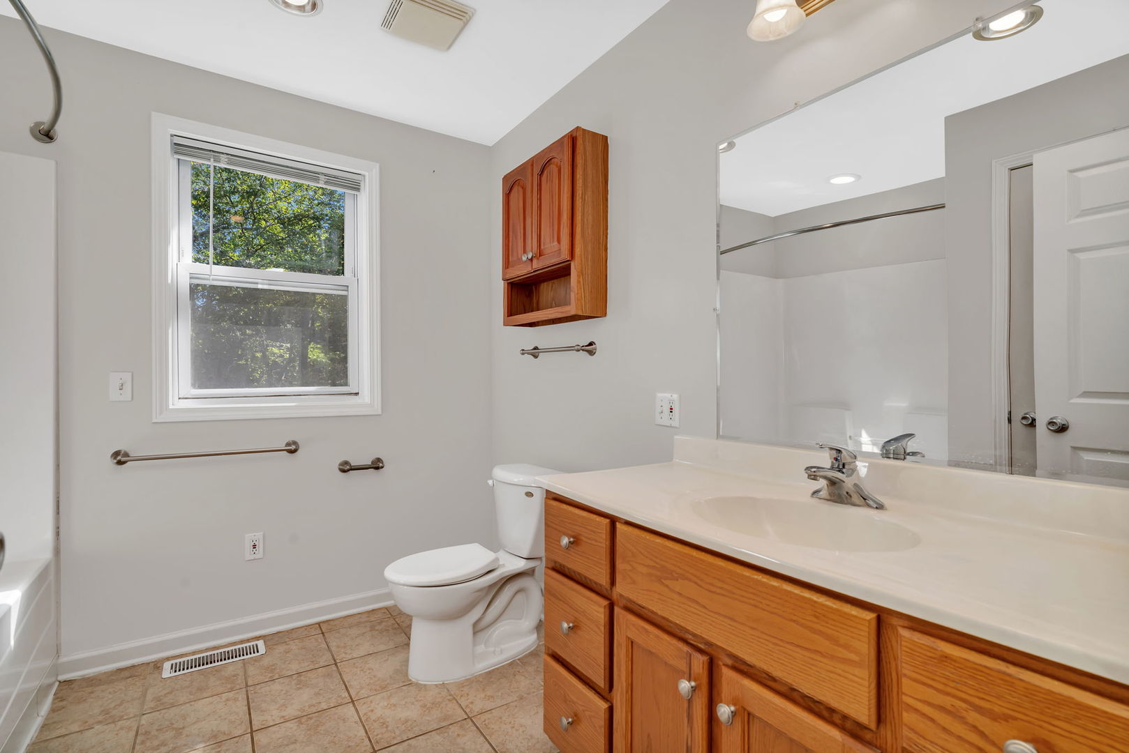 212 East Chippewa Street Dwight, IL 60420 - Photo 8 of 32 a bathroom with a sink toilet and a mirror