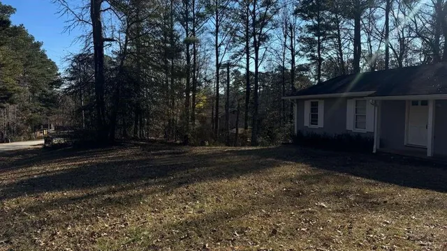 a view of a yard with large trees